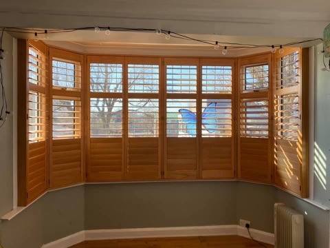 Wooden plantation shutters in a bay window